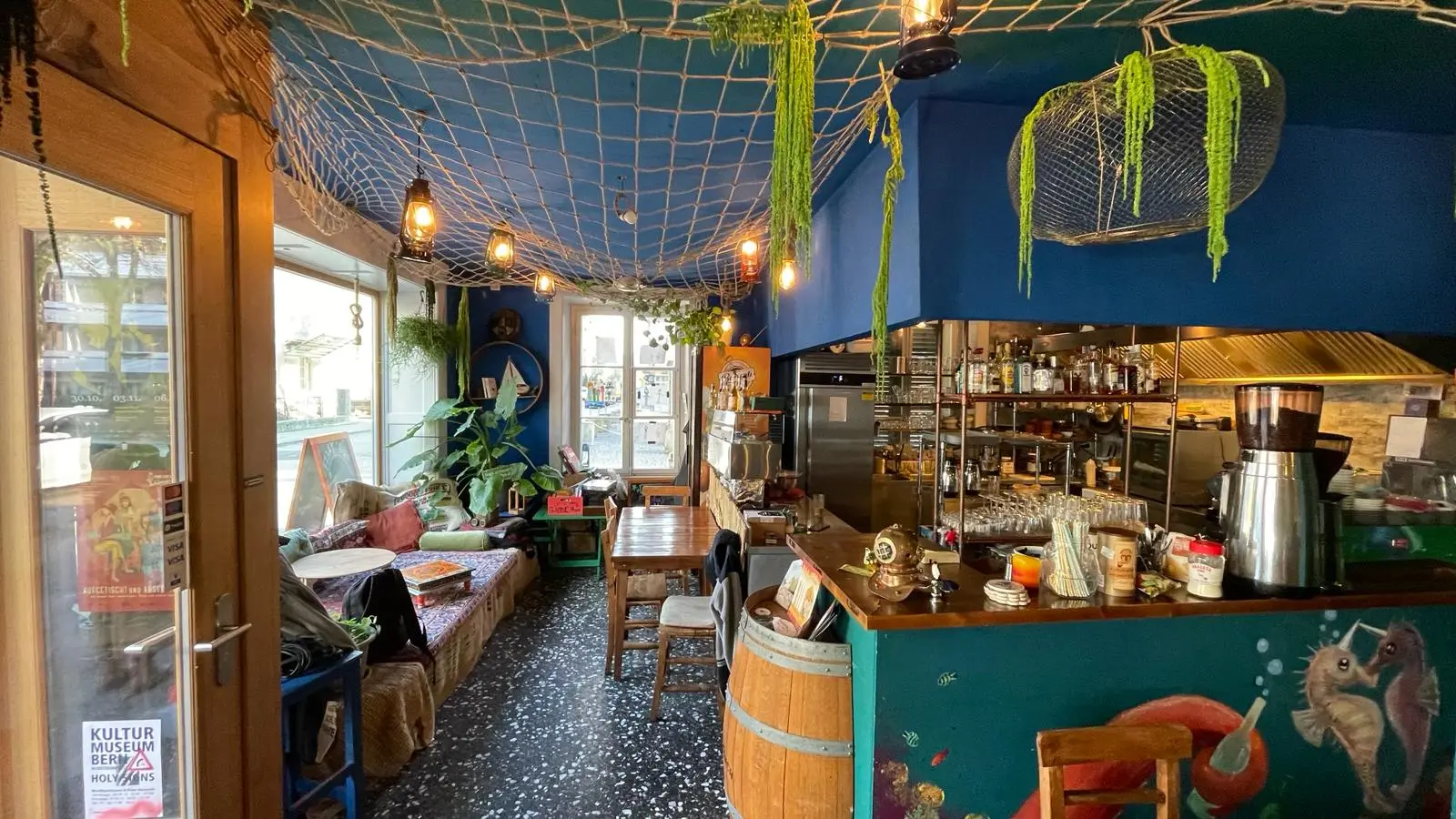 Falafingo’s colourful dining room with wooden tables, plants and nautical details